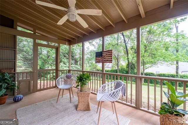 sunroom / solarium featuring a healthy amount of sunlight and ceiling fan
