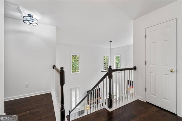 stairs featuring baseboards and wood finished floors