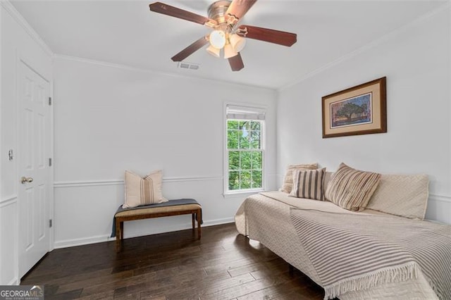 bedroom featuring crown molding, baseboards, visible vents, and wood-type flooring