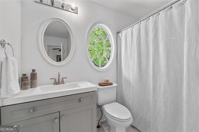 full bath featuring toilet and vanity