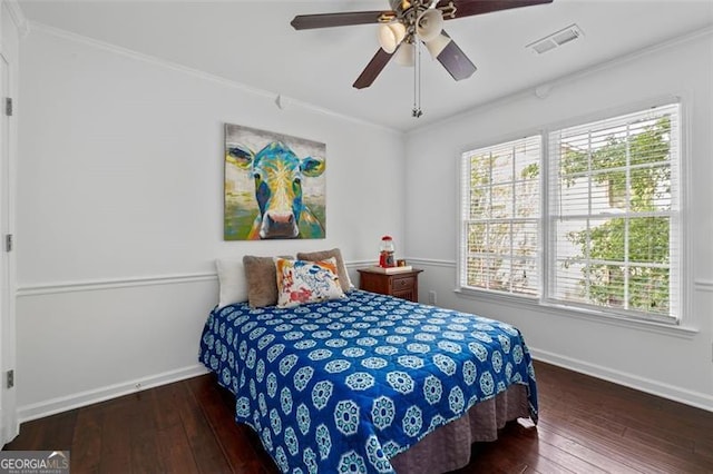 bedroom featuring crown molding, baseboards, hardwood / wood-style floors, and visible vents