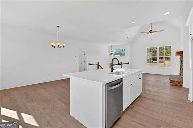 kitchen with decorative light fixtures, dishwasher, a sink, ceiling fan with notable chandelier, and light wood-style flooring