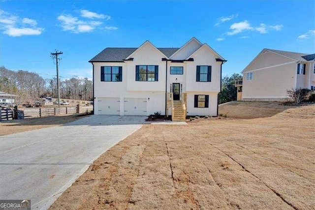 bi-level home with an attached garage and driveway