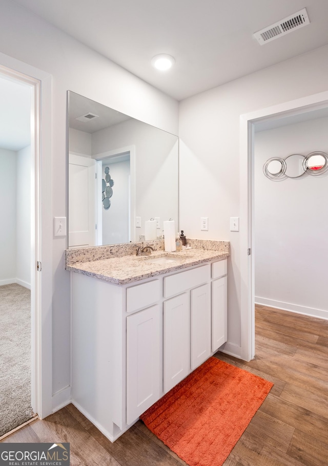 1341 Midnight Ride Ct, Hampton, GA 30228 - bathroom with visible vents, baseboards, wood finished floors, and vanity