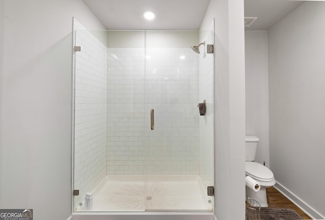 1341 Midnight Ride Ct, Hampton, GA 30228 - full bath featuring wood finished floors, toilet, baseboards, recessed lighting, and a stall shower