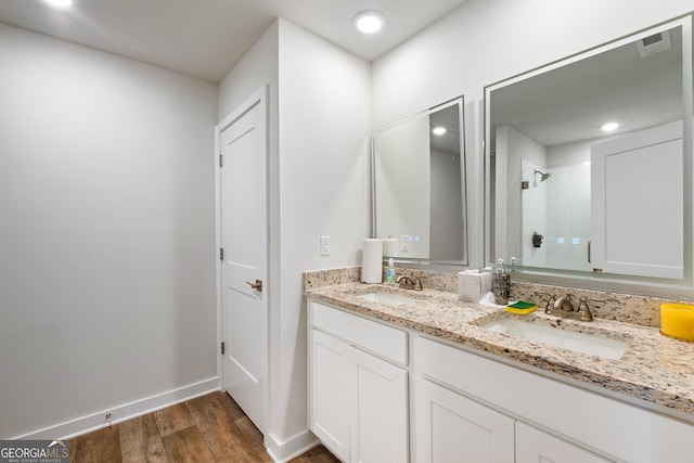 1341 Midnight Ride Ct, Hampton, GA 30228 - bathroom featuring double vanity, a sink, wood finished floors, and a shower stall
