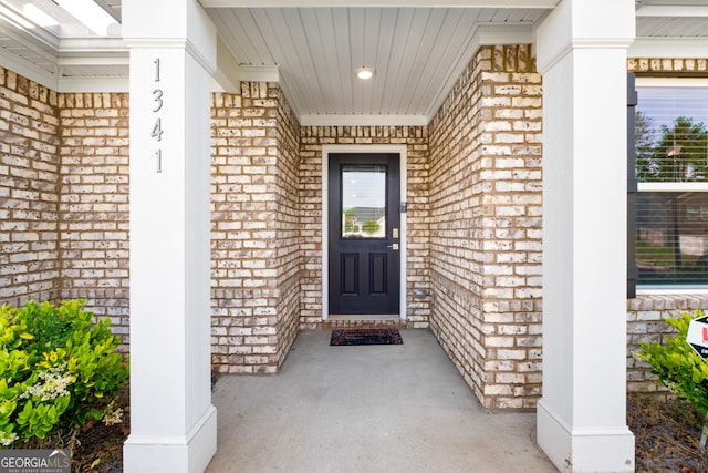 1341 Midnight Ride Ct, Hampton, GA 30228 - doorway to property with covered porch and brick siding