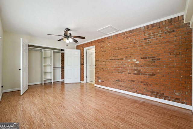 6545 Westbrook Rd, Gainesville, GA 30506 - unfurnished bedroom featuring light wood finished floors, brick wall, attic access, baseboards, and visible vents