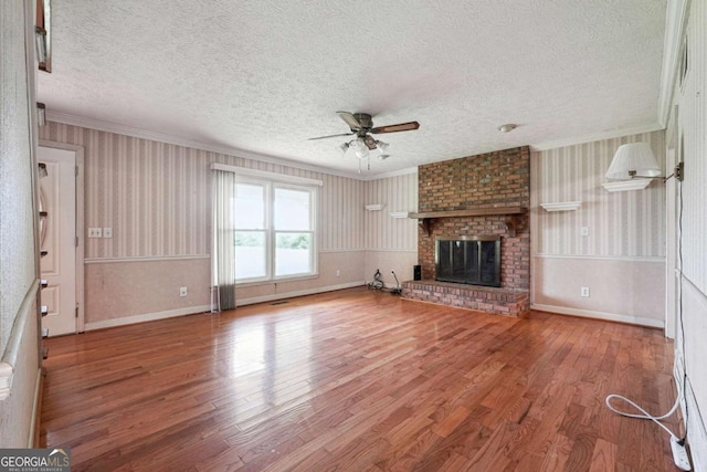 6545 Westbrook Rd, Gainesville, GA 30506 - unfurnished living room featuring a textured ceiling, ceiling fan, ornamental molding, and wood finished floors
