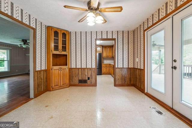 6545 Westbrook Rd, Gainesville, GA 30506 - unfurnished dining area with a ceiling fan, wallpapered walls, visible vents, and wainscoting
