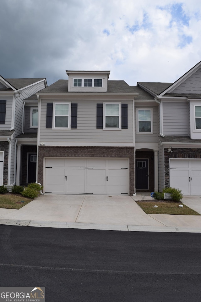 townhome / multi-family property featuring a garage and concrete driveway