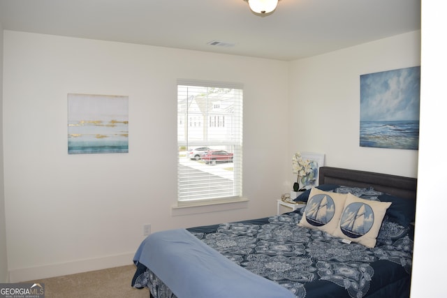 bedroom featuring carpet floors, baseboards, and visible vents