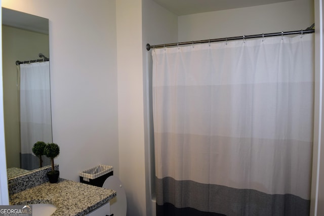 bathroom featuring vanity, toilet, and a shower with shower curtain