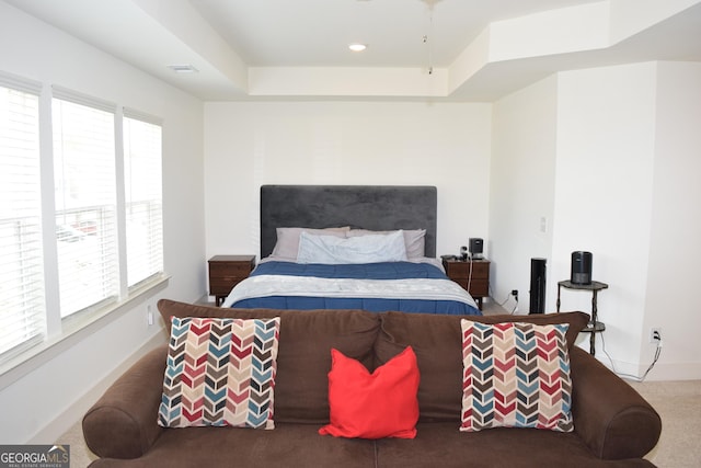 bedroom featuring carpet floors, visible vents, baseboards, recessed lighting, and a tray ceiling