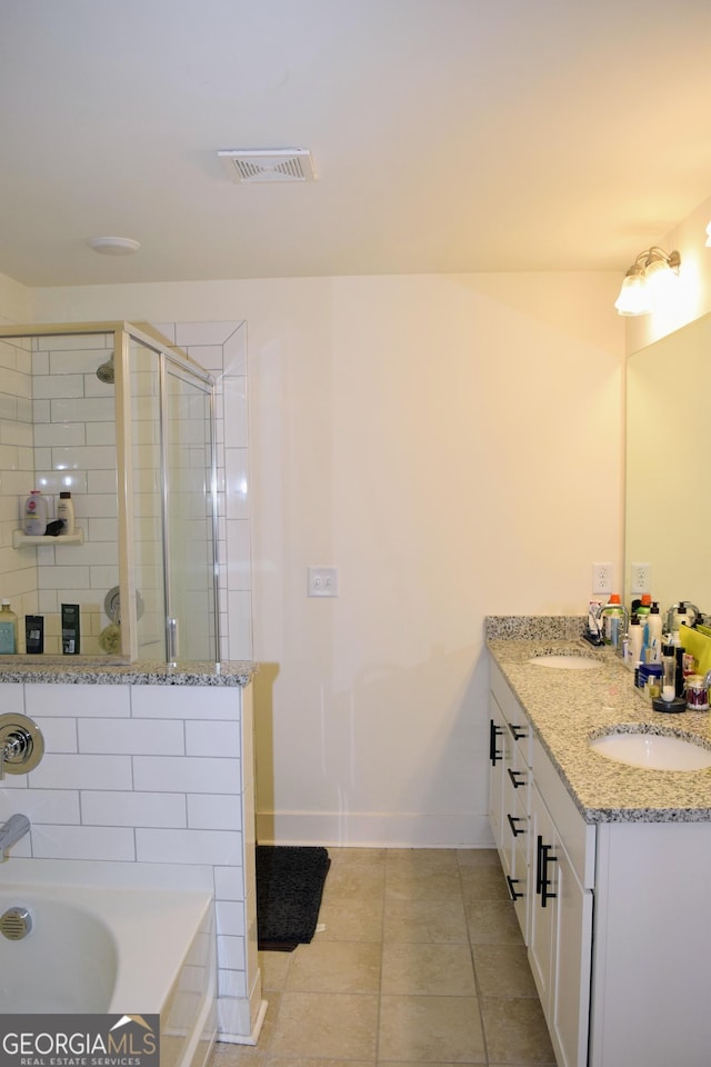 full bathroom featuring baseboards, a shower stall, a sink, and tile patterned flooring