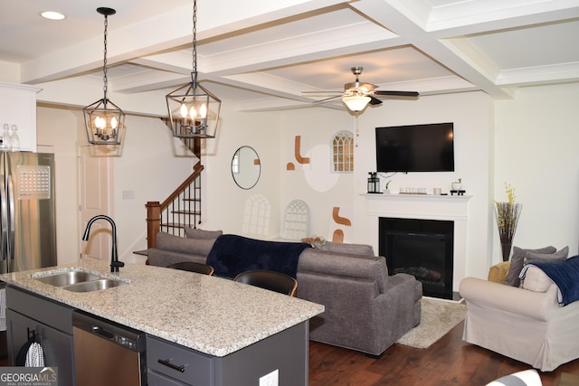 living room with a ceiling fan, a fireplace, beamed ceiling, coffered ceiling, and dark wood-type flooring
