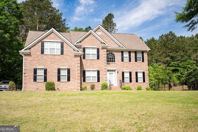 105 Kellens Ct, Fayetteville, GA 30215 - colonial house with brick siding, fence, roof with shingles, and a front lawn