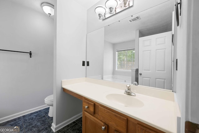 full bath with toilet, baseboards, vanity, tile patterned floors, and a tub to relax in