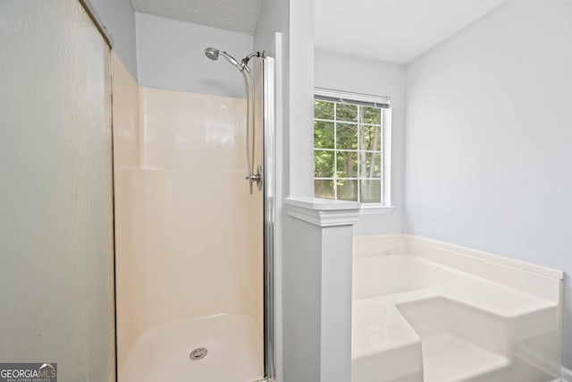 bathroom featuring a stall shower and a textured ceiling