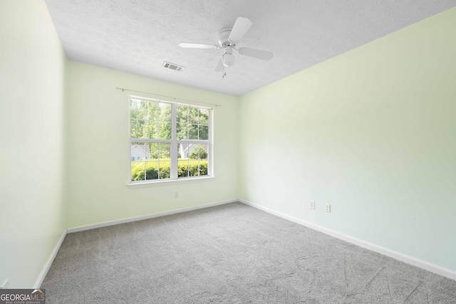 unfurnished room with baseboards, carpet flooring, ceiling fan, and a textured ceiling