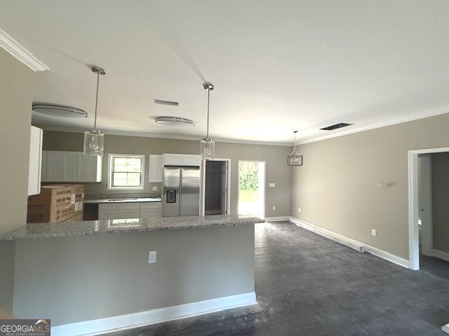 0 Worth St, Poulan, GA 31781 - kitchen featuring stainless steel fridge, ornamental molding, light stone counters, a peninsula, and baseboards