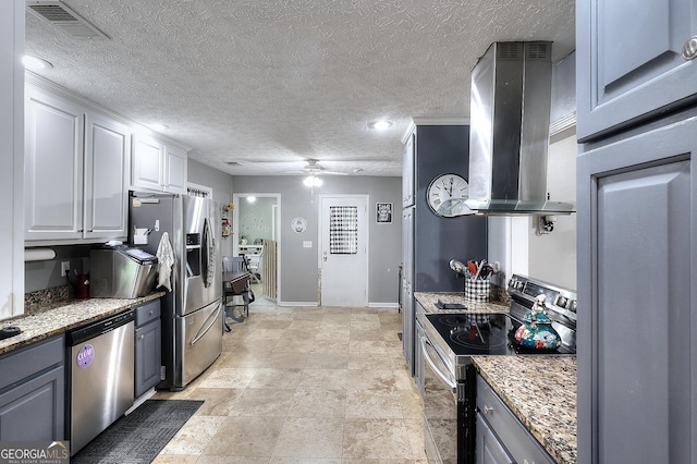 kitchen with appliances with stainless steel finishes, a textured ceiling, a ceiling fan, island exhaust hood, and visible vents