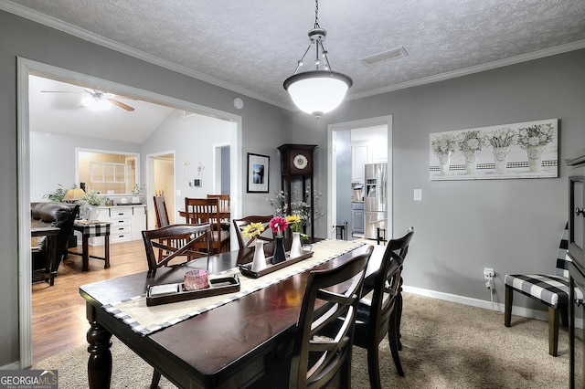 dining area with ornamental molding, a ceiling fan, and visible vents
