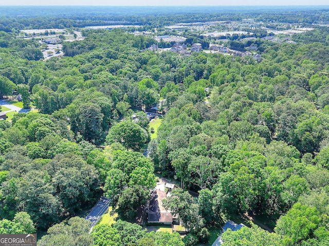 drone / aerial view featuring a view of trees