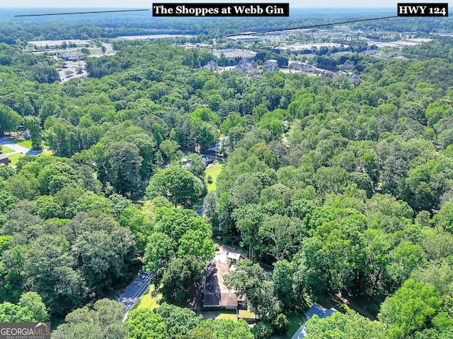bird's eye view with a wooded view