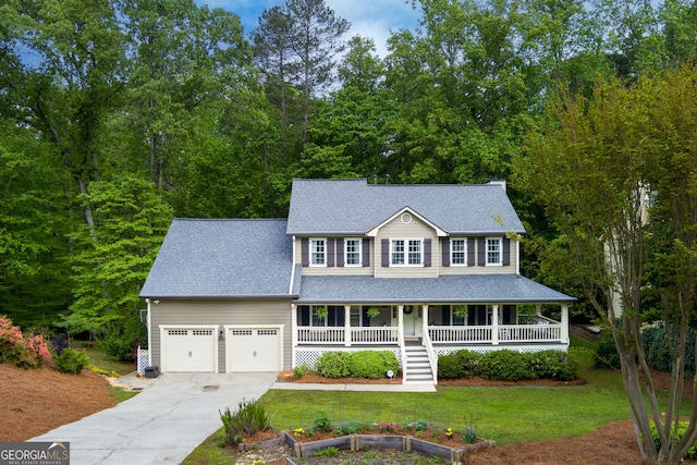 colonial-style house with roof with shingles, a front lawn, a garage, covered porch, and driveway