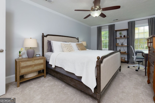 carpeted bedroom with baseboards, ornamental molding, a ceiling fan, and visible vents