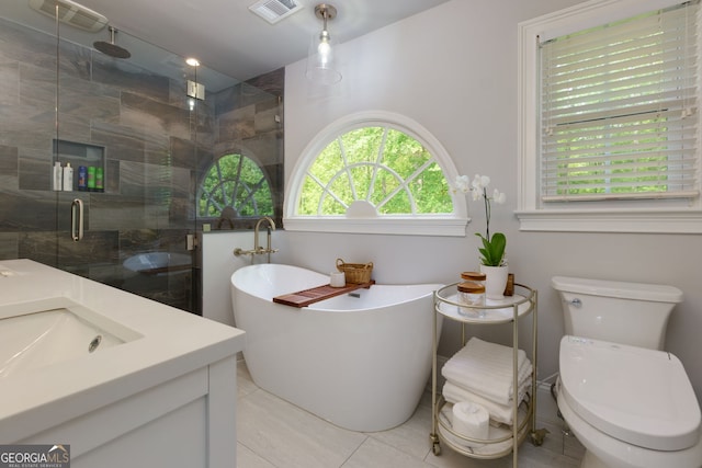 full bathroom featuring visible vents, a freestanding tub, tile patterned flooring, and a shower stall