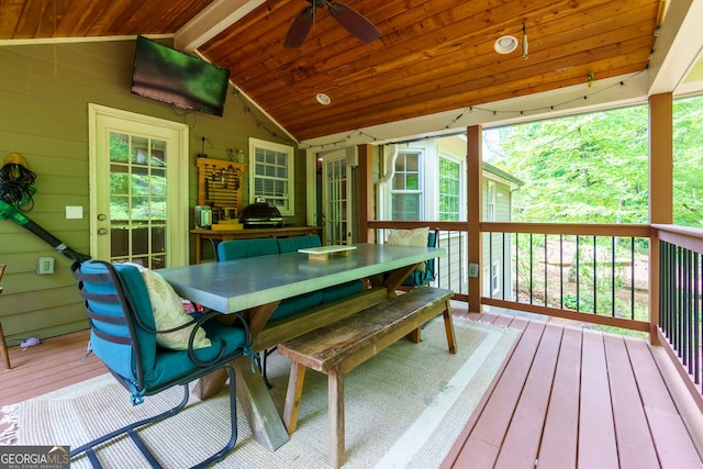 sunroom / solarium featuring a ceiling fan and outdoor dining area