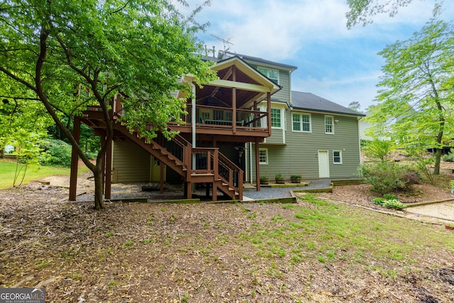 back of property featuring a wooden deck, stairway, and a patio