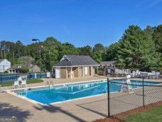 community pool featuring fence and a patio area