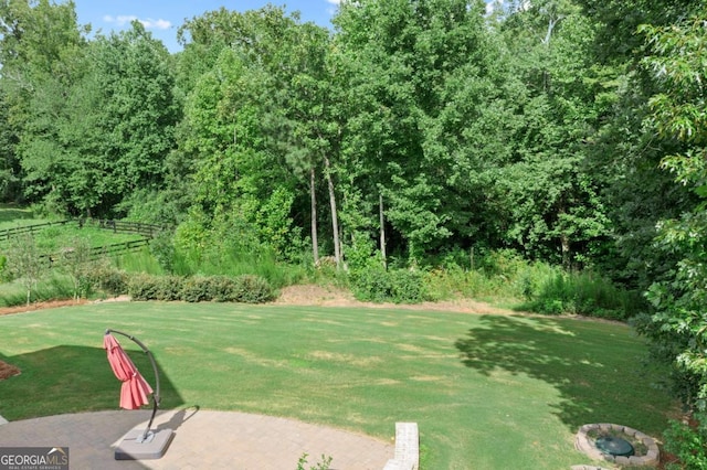 view of yard featuring fence and a patio area