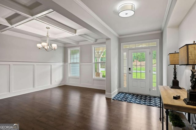 entryway with dark wood-style flooring, a notable chandelier, beam ceiling, a decorative wall, and coffered ceiling