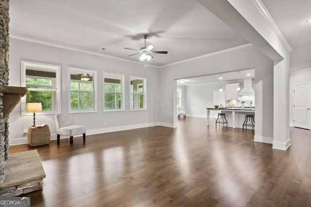 living area featuring crown molding, a ceiling fan, baseboards, and dark wood-style floors