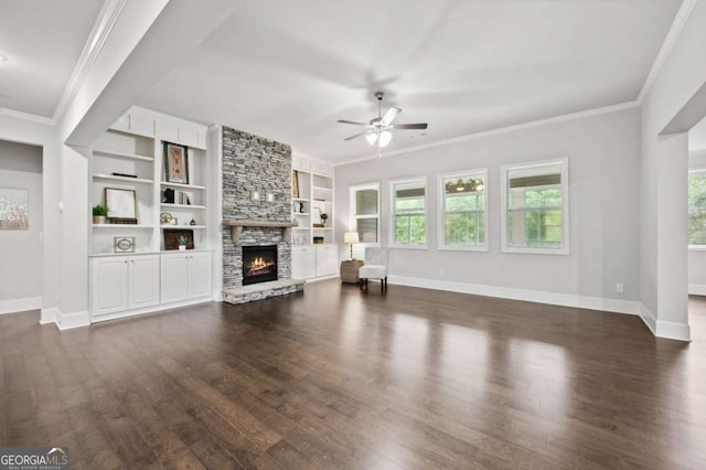 unfurnished living room with baseboards, dark wood-style flooring, ceiling fan, and a stone fireplace