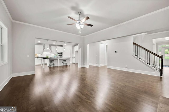 unfurnished living room with baseboards, a ceiling fan, dark wood-style floors, and stairs