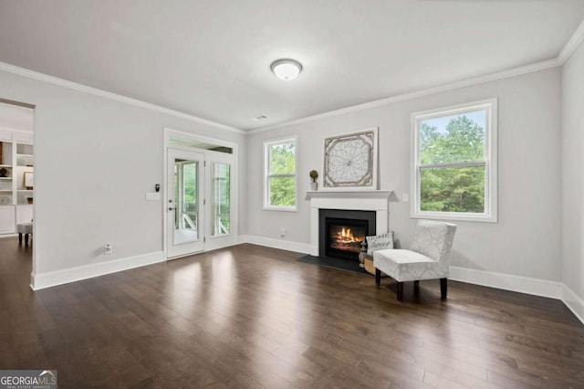 living area featuring a fireplace with flush hearth, baseboards, crown molding, and dark wood finished floors
