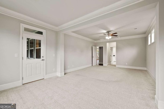 spare room featuring baseboards, light colored carpet, ornamental molding, and ceiling fan