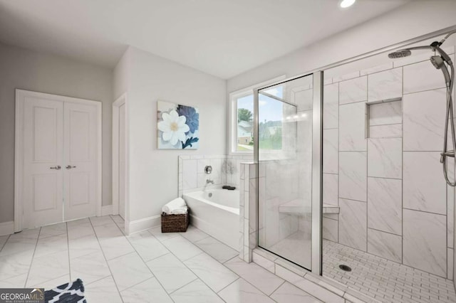 full bathroom with marble finish floor, baseboards, recessed lighting, a bath, and a shower stall