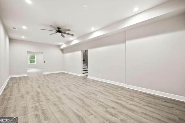 below grade area with recessed lighting, stairs, and wood finished floors