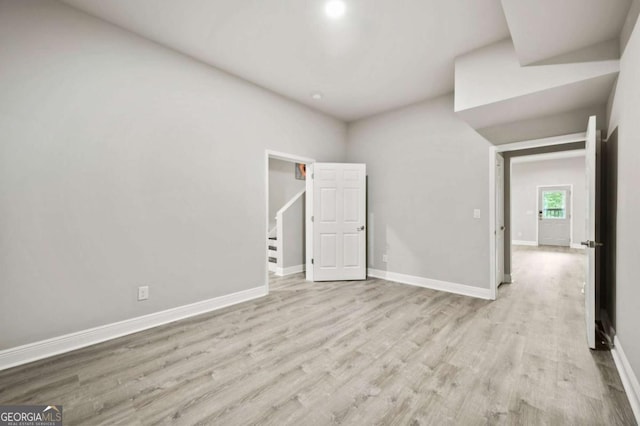empty room featuring baseboards and wood finished floors
