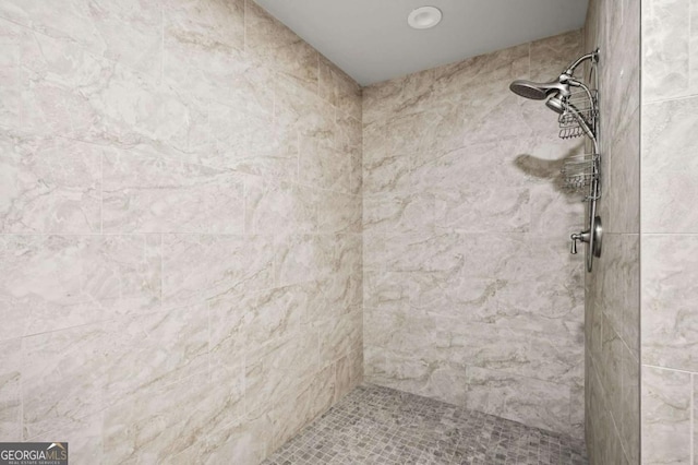 full bath featuring a tile shower