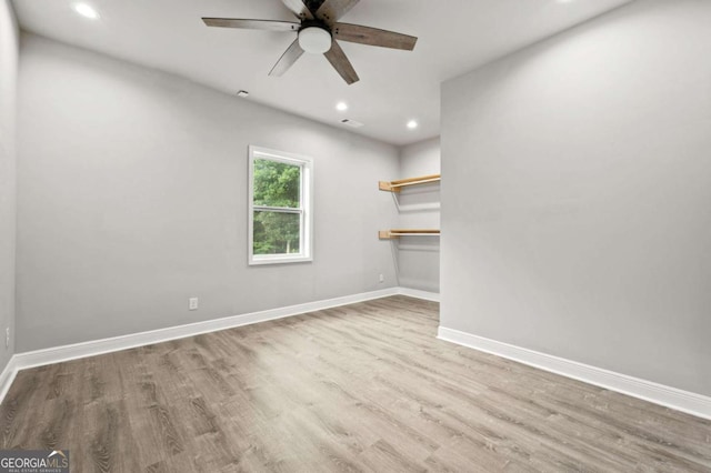 empty room with baseboards, a ceiling fan, recessed lighting, and wood finished floors
