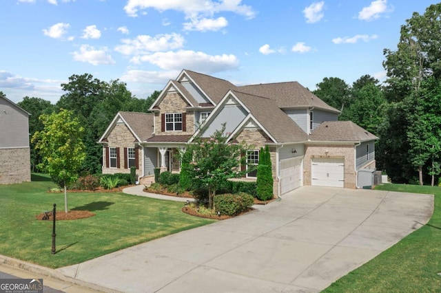 craftsman house with a garage, concrete driveway, a front lawn, and stone siding