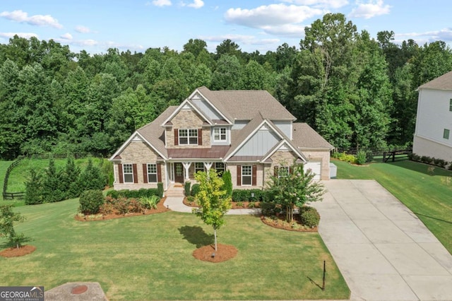 craftsman house featuring fence, stone siding, board and batten siding, a porch, and driveway
