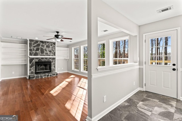 interior space with a ceiling fan, baseboards, and visible vents